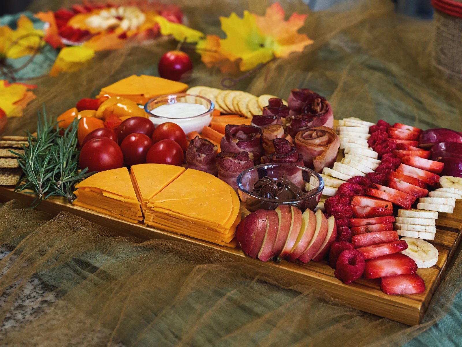 Tray of various fruits and vegetables with bacon products